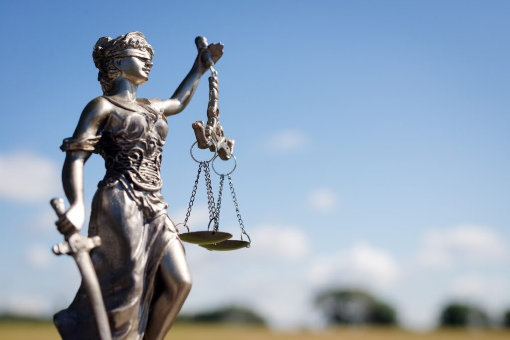 The statue of lady justice against blue sky